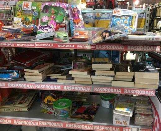 Slika 24 prodaja knjiga u supermarketu Slika prikazuje knjige na polici u supermarketu među drugim predmetima popust igračaka.